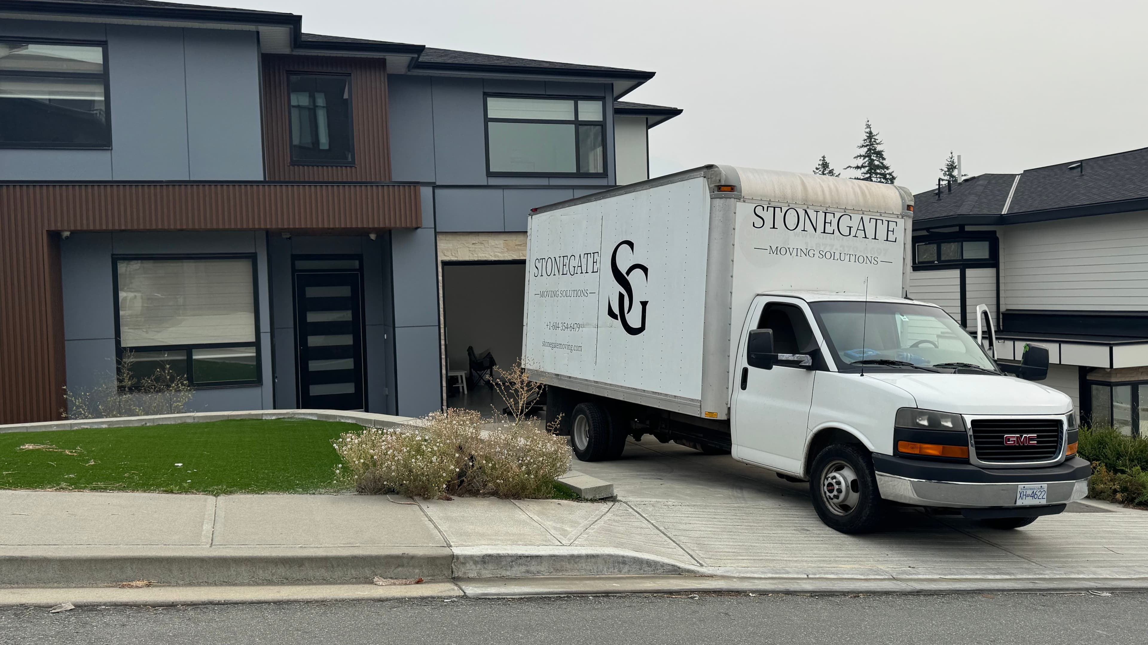 Stonegate Moving Solutions truck outside a home